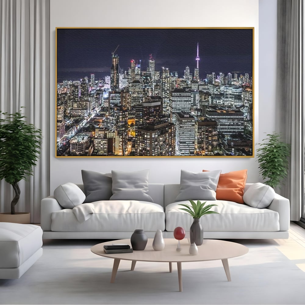 Tablou canvas cu panoramic nocturn cu toronto si cn tower, in rama de aluminiu auriu, pe perete intr-un living